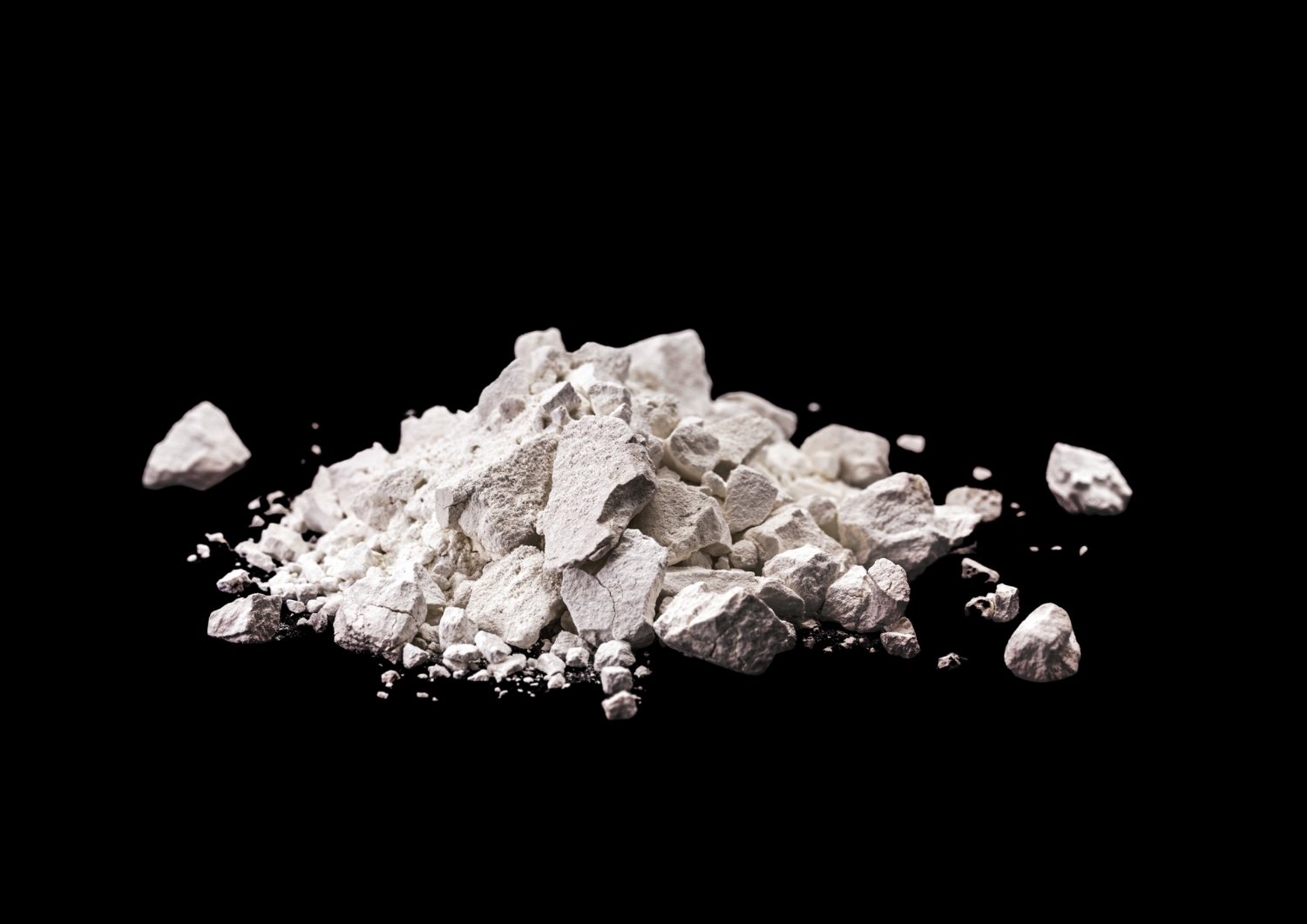 Extracted through quarrying, used in construction as a building material, in cement, and for soil conditioning in agriculture.